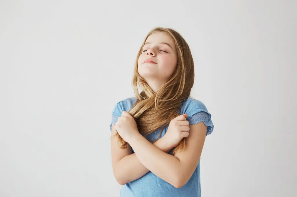 Girl breathes deeply, eyes closed, well-being